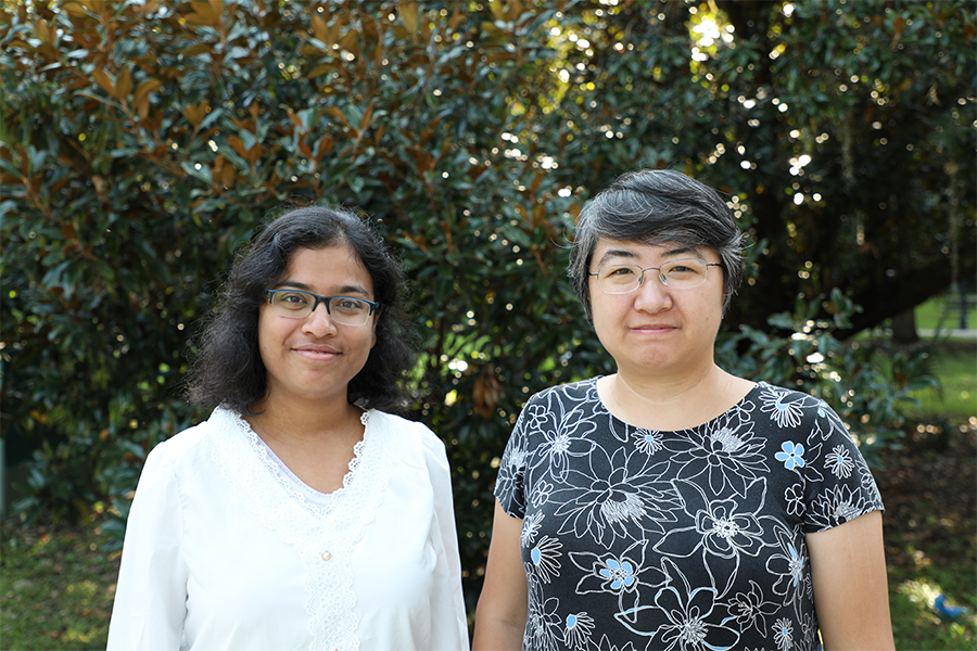 FSU biological science postdoctoral fellow Debipreeta Bhowmik and assistant professor of biological science Qian Yin standing side by side in front of a tree. Photo by McKenzie Harris.