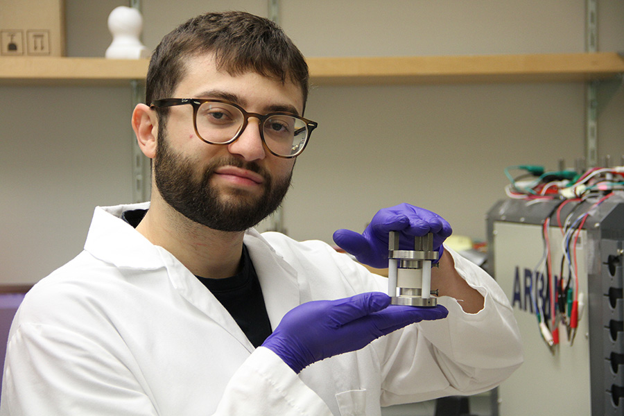 This is a photo of Michael Deck holding the lithium-ion battery he created.