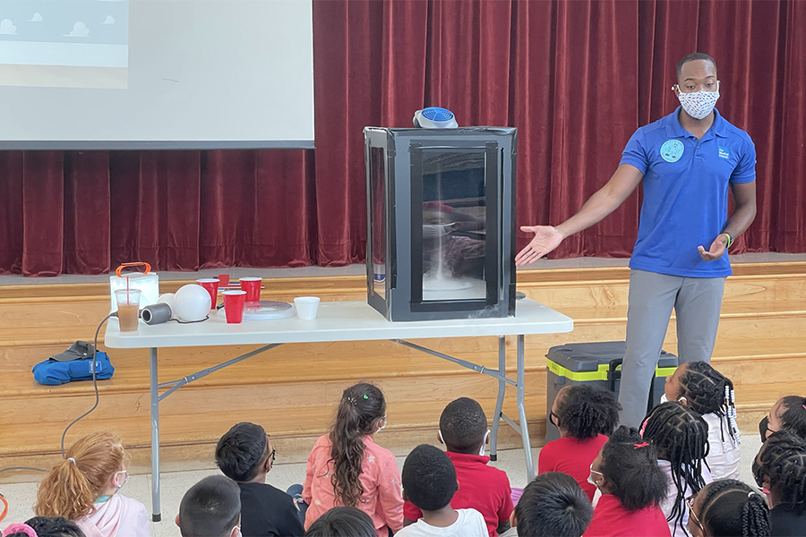 Tevin Wooten teaches elementary students the science behind weather phenomena. Courtesy photo.