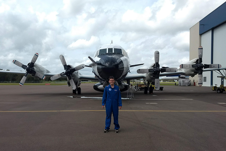Andrew Hazelton standing outside a NOAA Aircraft Operations Center plane. Courtesy Andrew Hazelton.