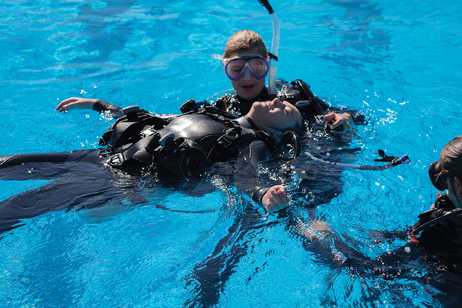 Students perform a rescue drill as part of the Introduction to Scientific Diving course. Photo by Kendall Cooper.